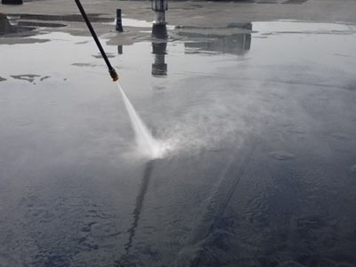 Commercial flat roof cleaning with pressure washer