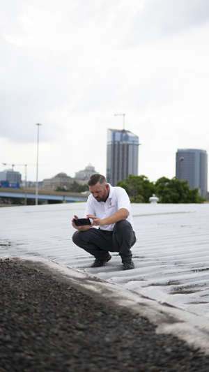 Taking photos during roof inspection in Humble, Texas