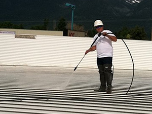 Pressure washing a metal roof