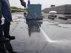 Pressure washing a commercial roof